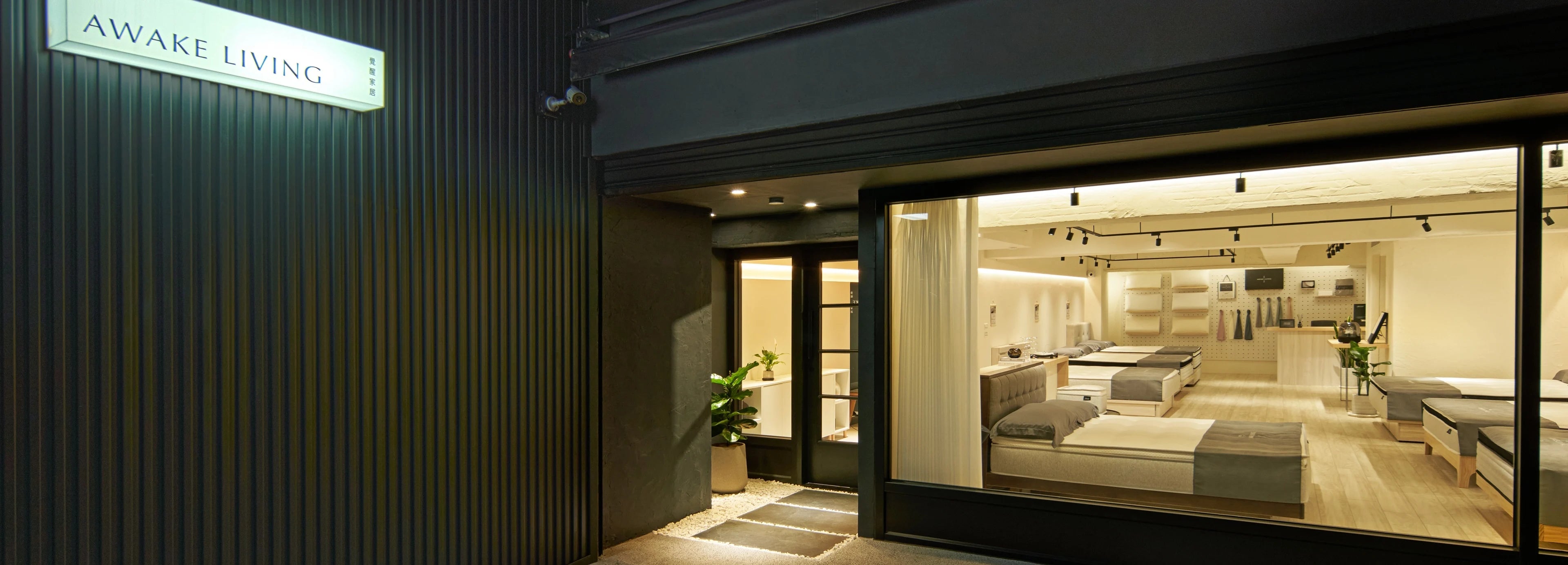 AWAKE LIVING 覺醒家居台北大安體驗店的門市入口與店內陳設，店外有發光的招牌。