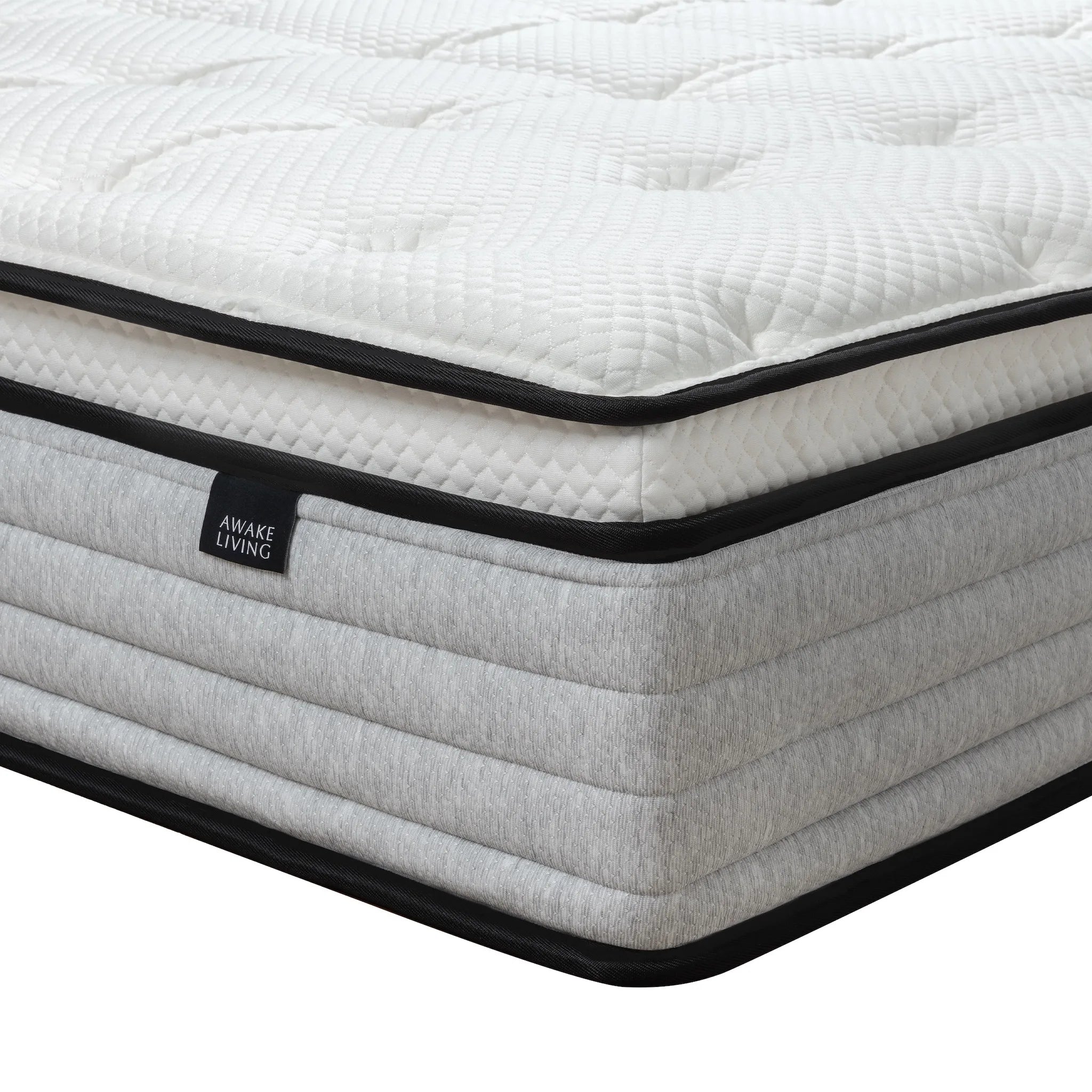 Deluxe AG 床墊的角落特寫，展示其 Pillow Top 設計與灰色橫紋床邊。